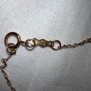 14 karat solid gold chain for women with a diamond inside of it. High quality